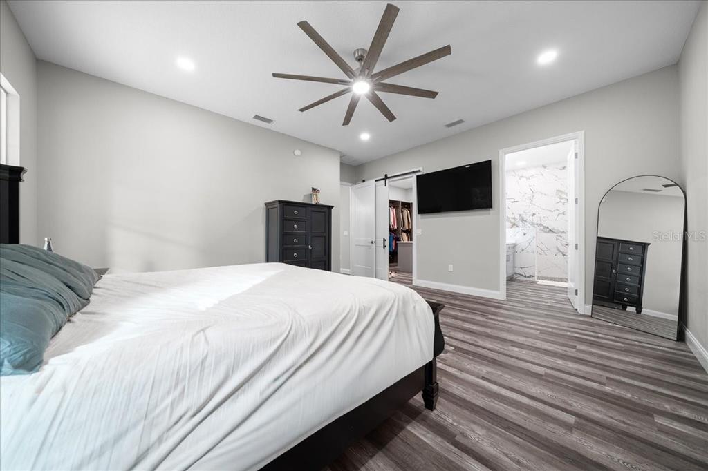 252 Malauka Road Ocklawaha, FL 32179 - Photo 25 of 78 a bedroom with a bed and a flat screen tv