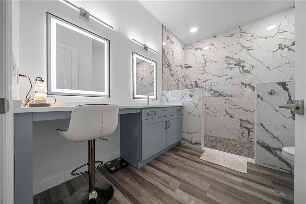 252 Malauka Road Ocklawaha, FL 32179 - Photo 28 of 78 a bathroom with a sink a toilet a mirror and shower