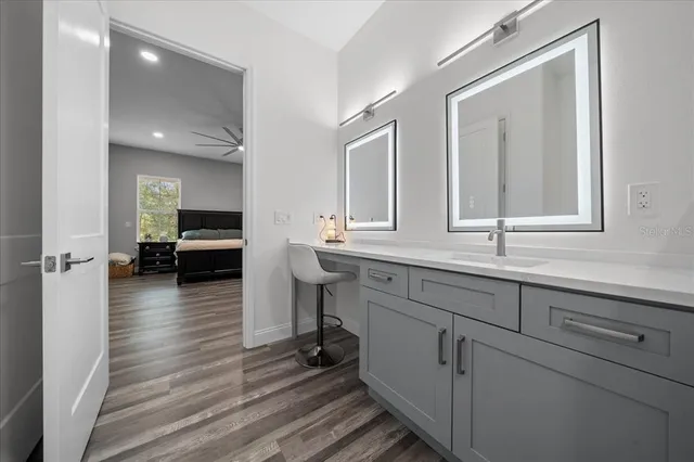 a view of a house with a yard and large tree