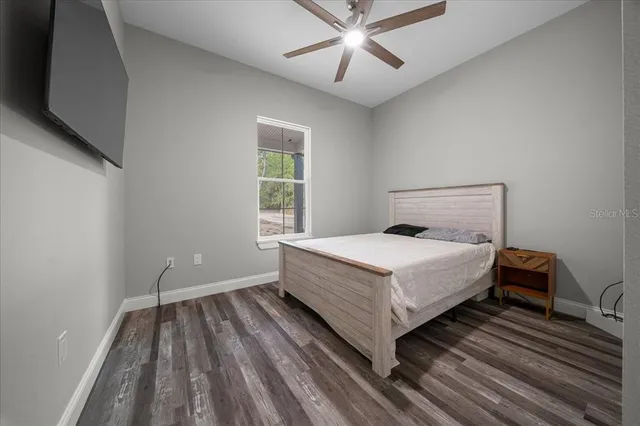 a backyard of a house with table and chairs