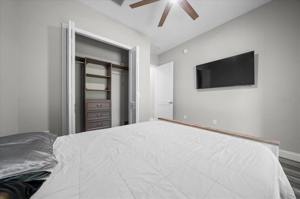 252 Malauka Road Ocklawaha, FL 32179 - Photo 34 of 78 a bedroom with a bed and a flat screen tv