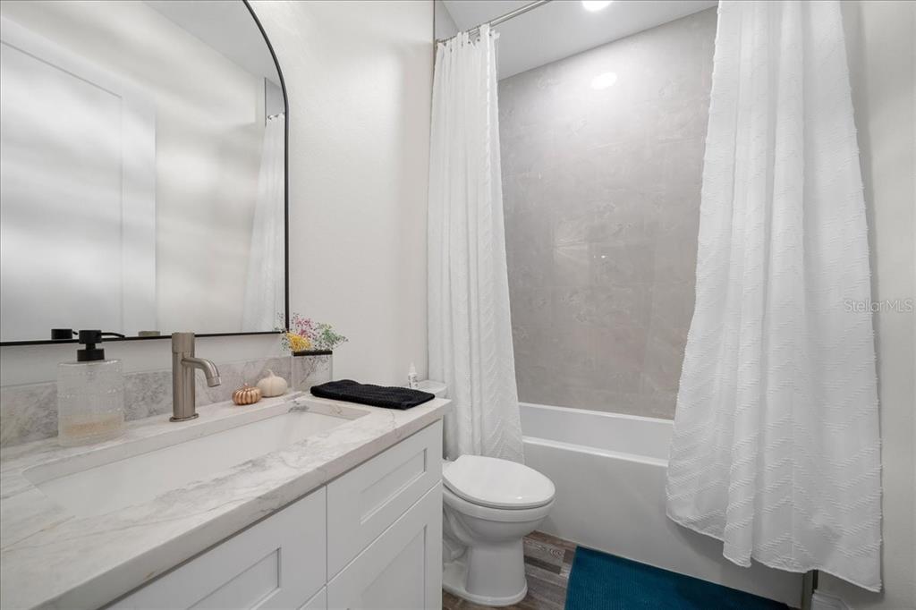 252 Malauka Road Ocklawaha, FL 32179 - Photo 36 of 78 a bathroom with a granite countertop sink and a mirror