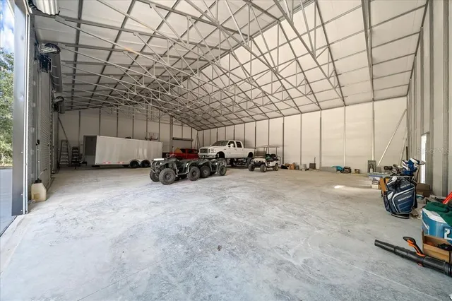 an aerial view of a house with a yard and lake view