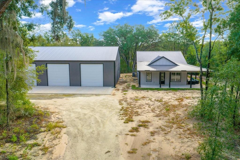 252 Malauka Road Ocklawaha, FL 32179 - Photo 46 of 78 a front view of a house with a yard and garage