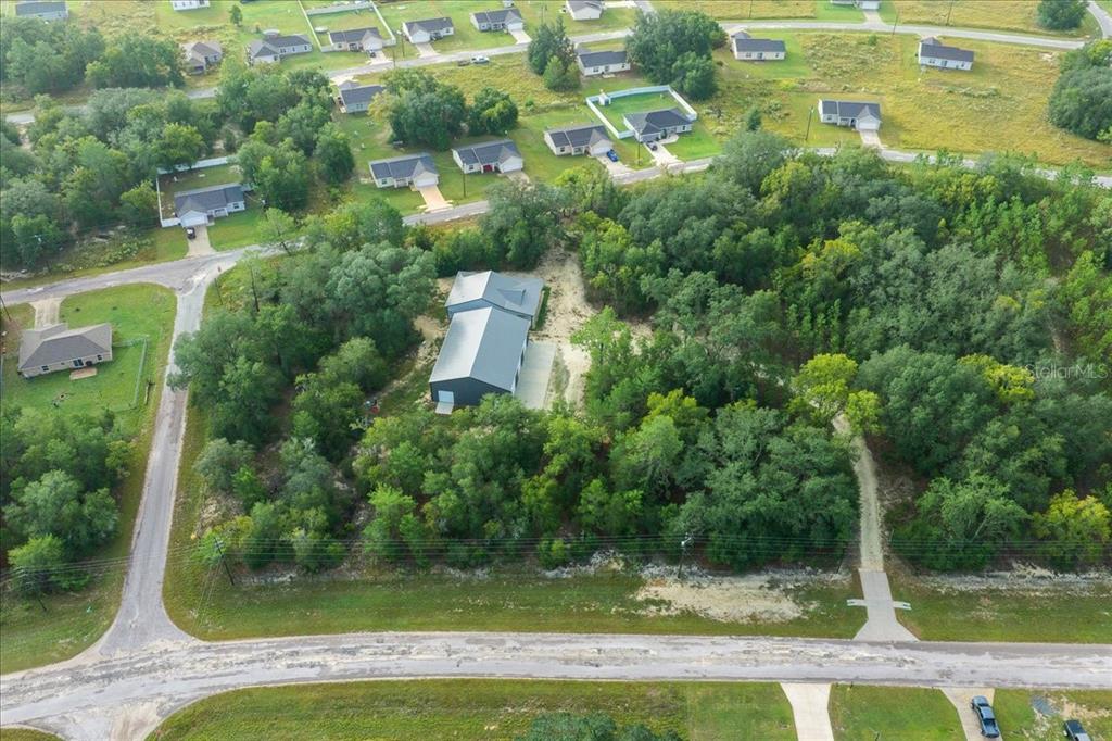252 Malauka Road Ocklawaha, FL 32179 - Photo 70 of 78 an aerial view of a house with yard swimming pool and outdoor seating