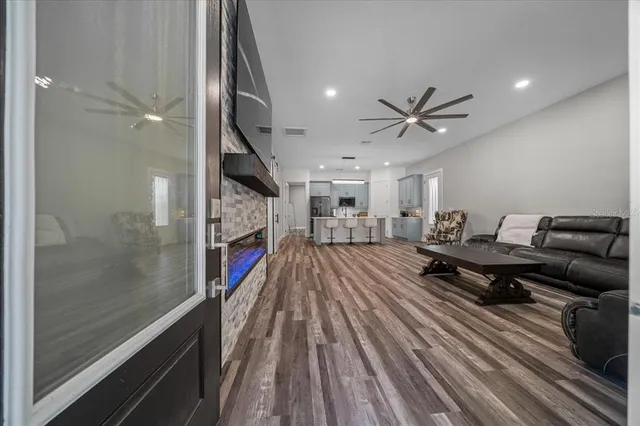 a living room with furniture and a wooden floor