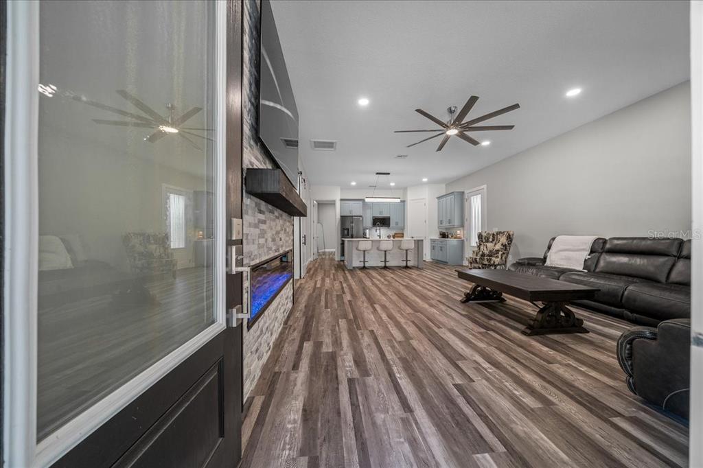 252 Malauka Road Ocklawaha, FL 32179 - Photo 8 of 78 a living room with furniture a fireplace and a chandelier