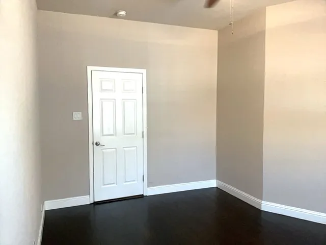 an empty room with wooden floor
