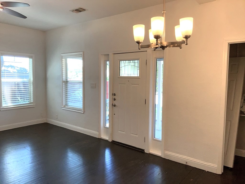 806 East 3rd Street Georgetown, TX 78626 - Photo 3 of 16 Entryway featuring plenty of natural light, dark wood-style flooring, and a chandelier
