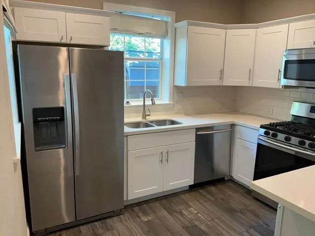a kitchen with a refrigerator stove and sink