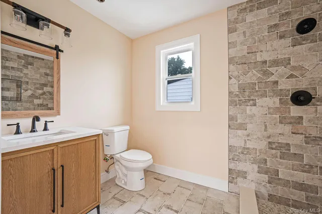 a bathroom with a sink a toilet and a shower