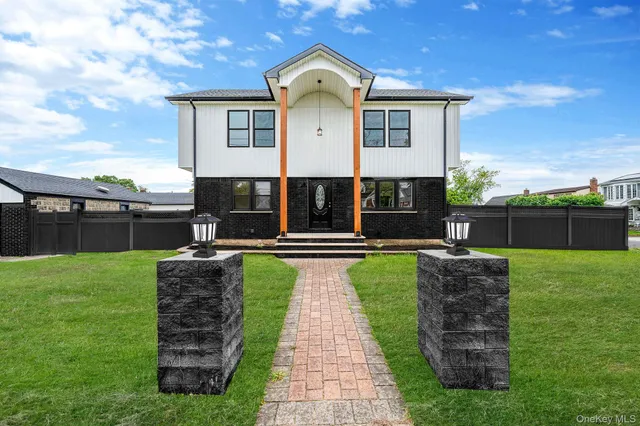 a front view of a house with a garden