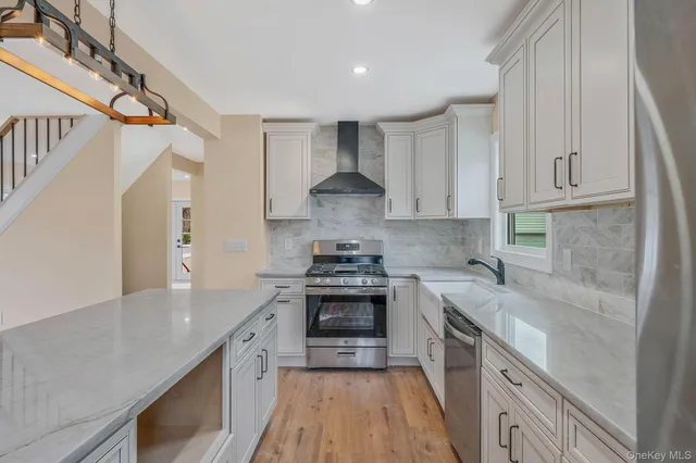 a kitchen with a stove sink and cabinets