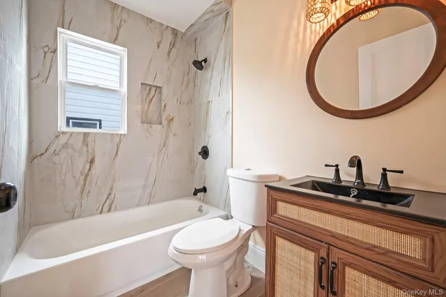 a bathroom with a sink a toilet and a mirror