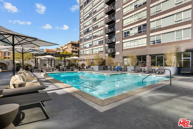 a view of a swimming pool with outdoor seating