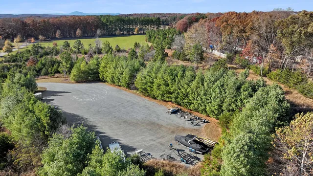 an aerial view of a house with a yard and lake view