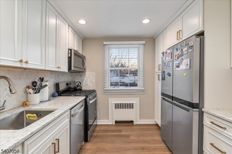 445 Morris Avenue, Unit 4C Springfield, NJ 07081 - Photo 11 of 19 a kitchen with a refrigerator and a sink