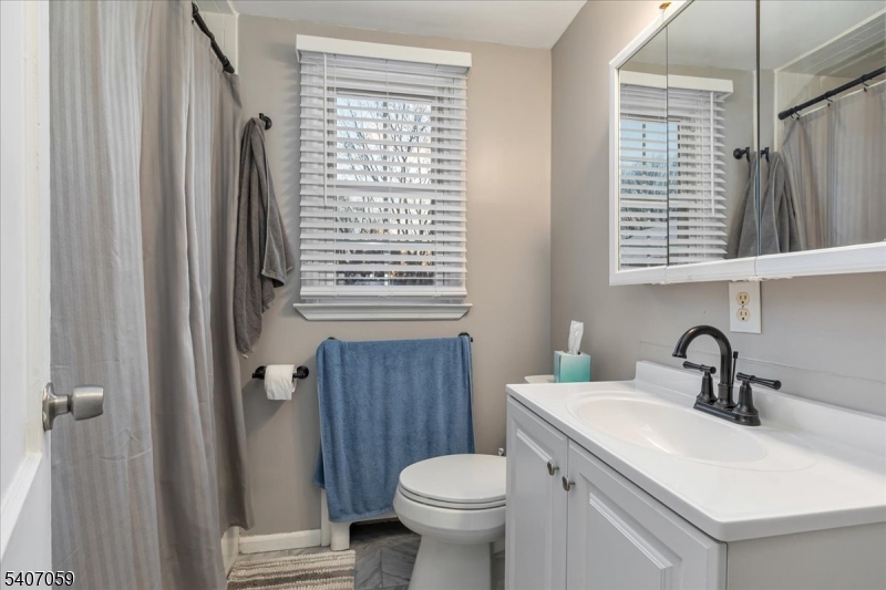 445 Morris Avenue, Unit 4C Springfield, NJ 07081 - Photo 2 of 19 a bathroom with a sink a toilet and a window