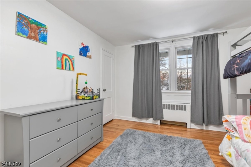 445 Morris Avenue, Unit 4C Springfield, NJ 07081 - Photo 4 of 19 a bedroom with a bed and a window