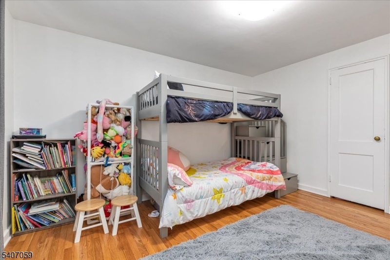 445 Morris Avenue, Unit 4C Springfield, NJ 07081 - Photo 5 of 19 a bedroom with a bed and a book shelf