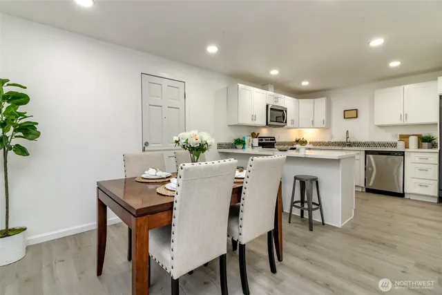 a kitchen with a table and chairs in it