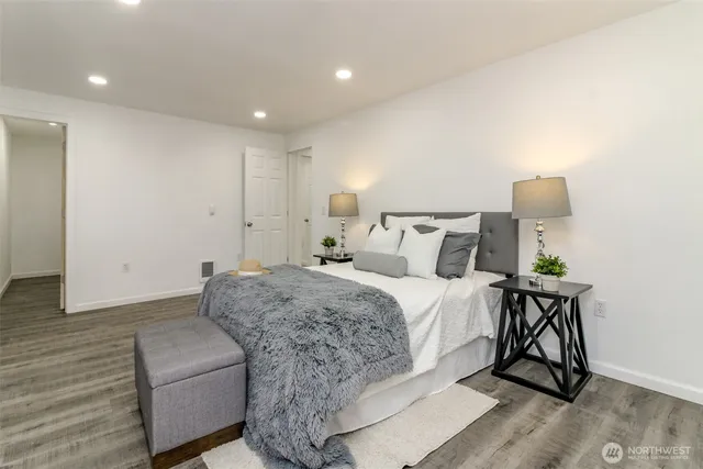 a bed room with a bed and a chair