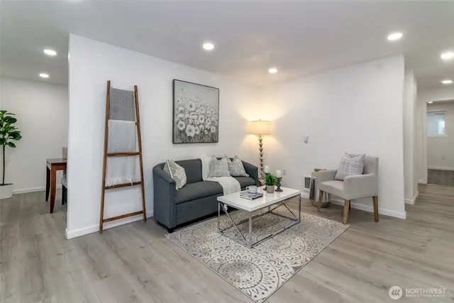 a living room with furniture and wooden floor