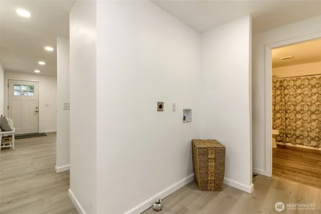 a view of room with walk in closet and wooden floor