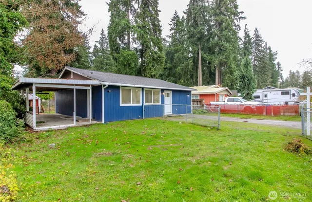 a view of a house with a backyard and a patio