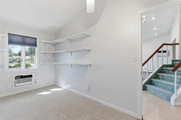 a view of hallway with stairs and wooden floor