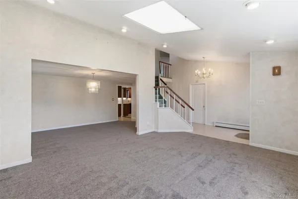 a view of an empty room with stairs