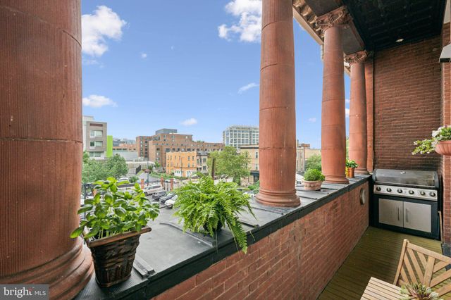 a balcony with wooden floor and furniture