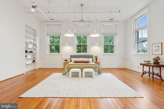a spacious bedroom with a bed and furniture