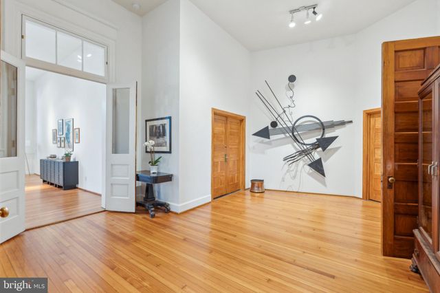 a living room with furniture or wooden floor and a large window