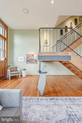 a living room with furniture a rug and a clock