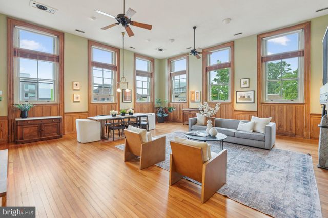 a view of a dining room with furniture and a chandelier