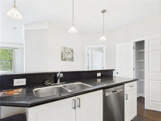 a kitchen with a sink a counter and cabinets