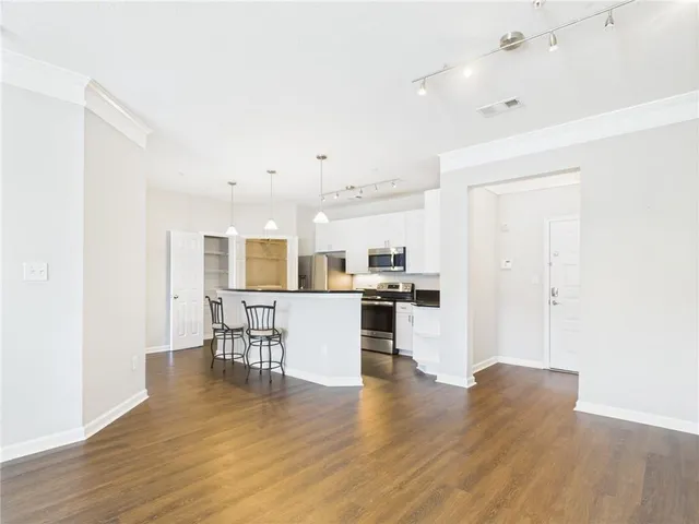 a living room with kitchen island furniture and a kitchen view