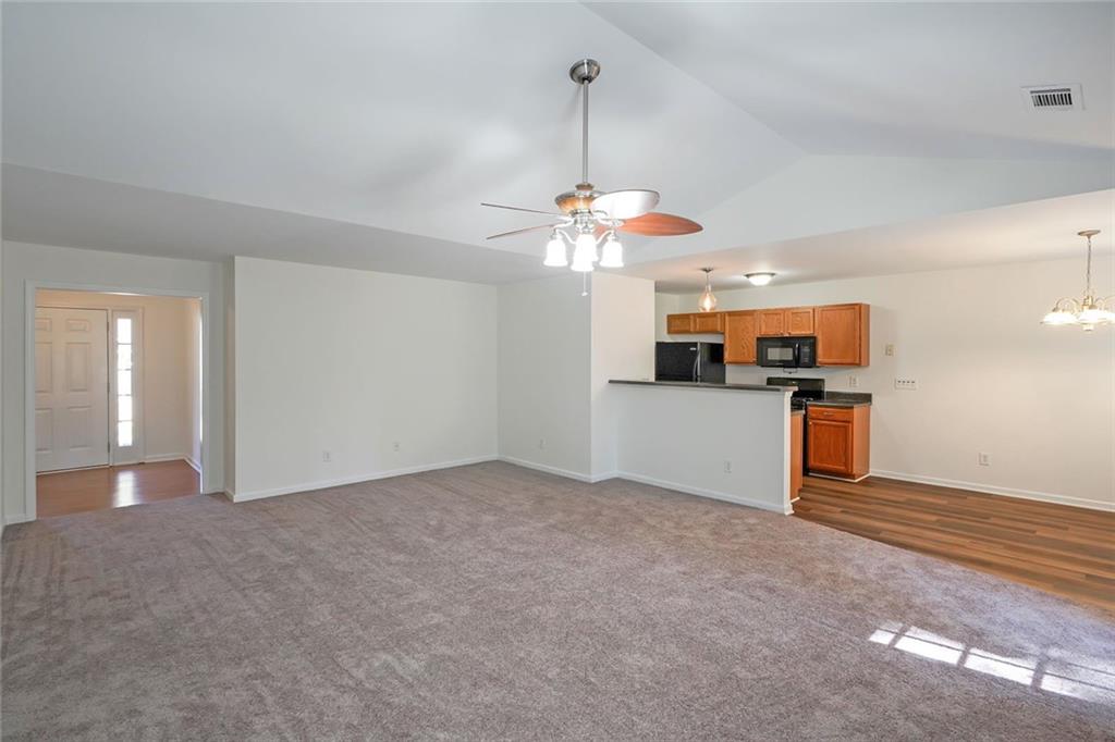 211 West Bridge Drive Dallas, GA 30157 - Photo 5 of 26 a view of a kitchen with a sink and dishwasher a refrigerator with wooden floor