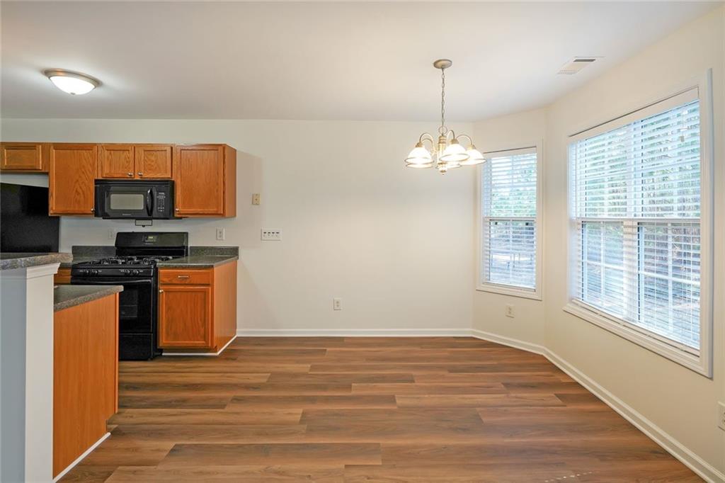 211 West Bridge Drive Dallas, GA 30157 - Photo 6 of 26 a kitchen with stainless steel appliances granite countertop a stove a sink and a refrigerator