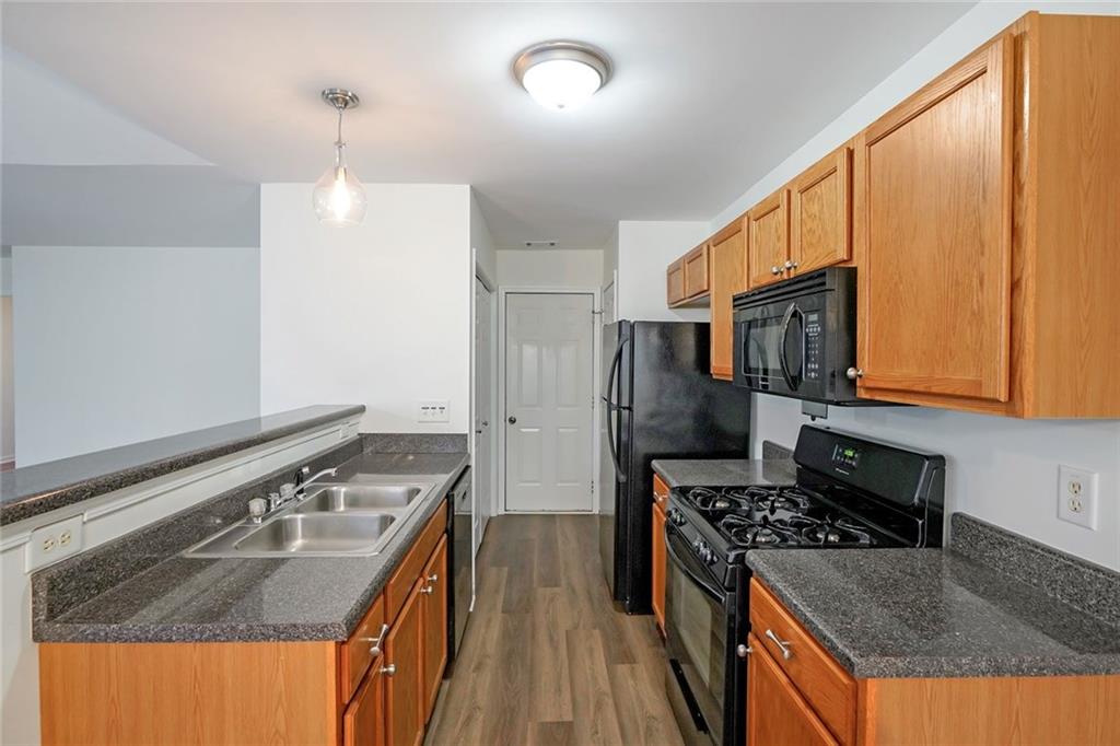 211 West Bridge Drive Dallas, GA 30157 - Photo 7 of 26 a kitchen with stainless steel appliances granite countertop a stove refrigerator and a sink