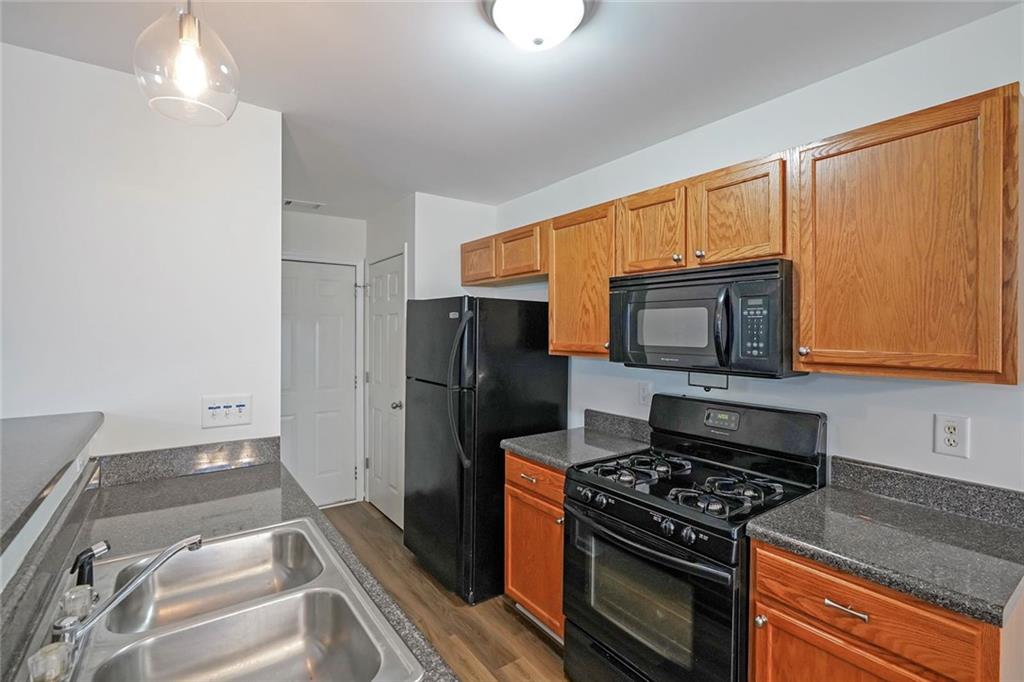 211 West Bridge Drive Dallas, GA 30157 - Photo 8 of 26 a kitchen with a stove and a microwave