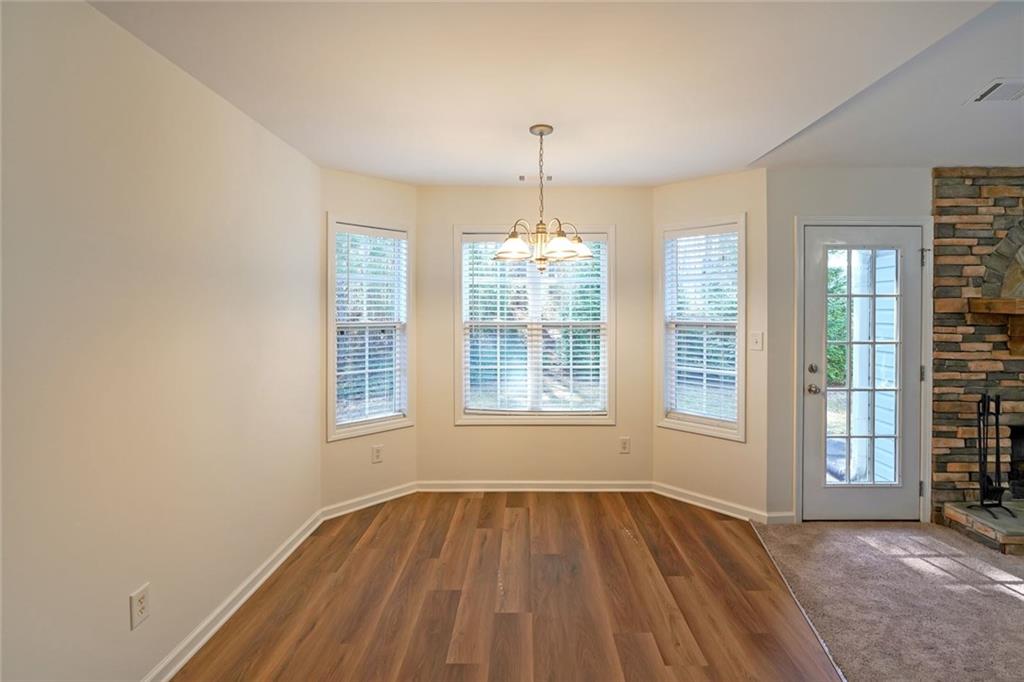 211 West Bridge Drive Dallas, GA 30157 - Photo 10 of 26 an empty room with wooden floor and windows
