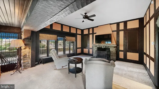 a view of a livingroom with an empty space and a fireplace