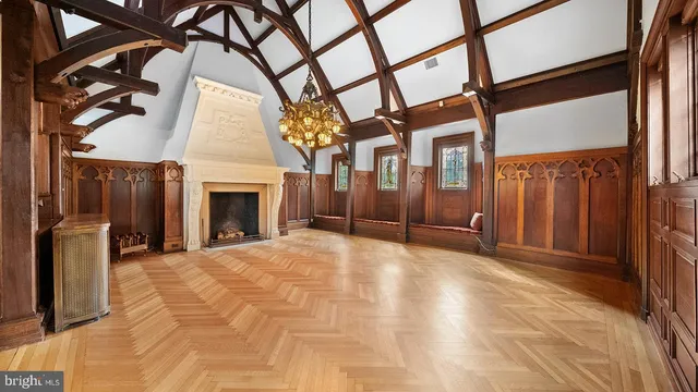 a living room with furniture and a large window with wooden floor