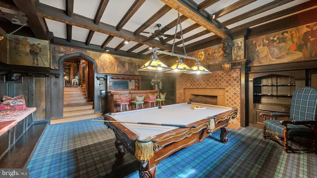 an empty room with wooden floor and ceiling fan