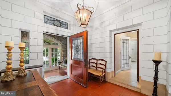 a living room with furniture a fireplace and a large window