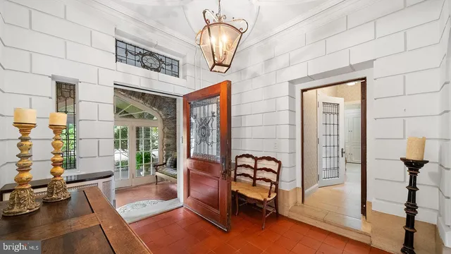 a living room with furniture a fireplace and a large window