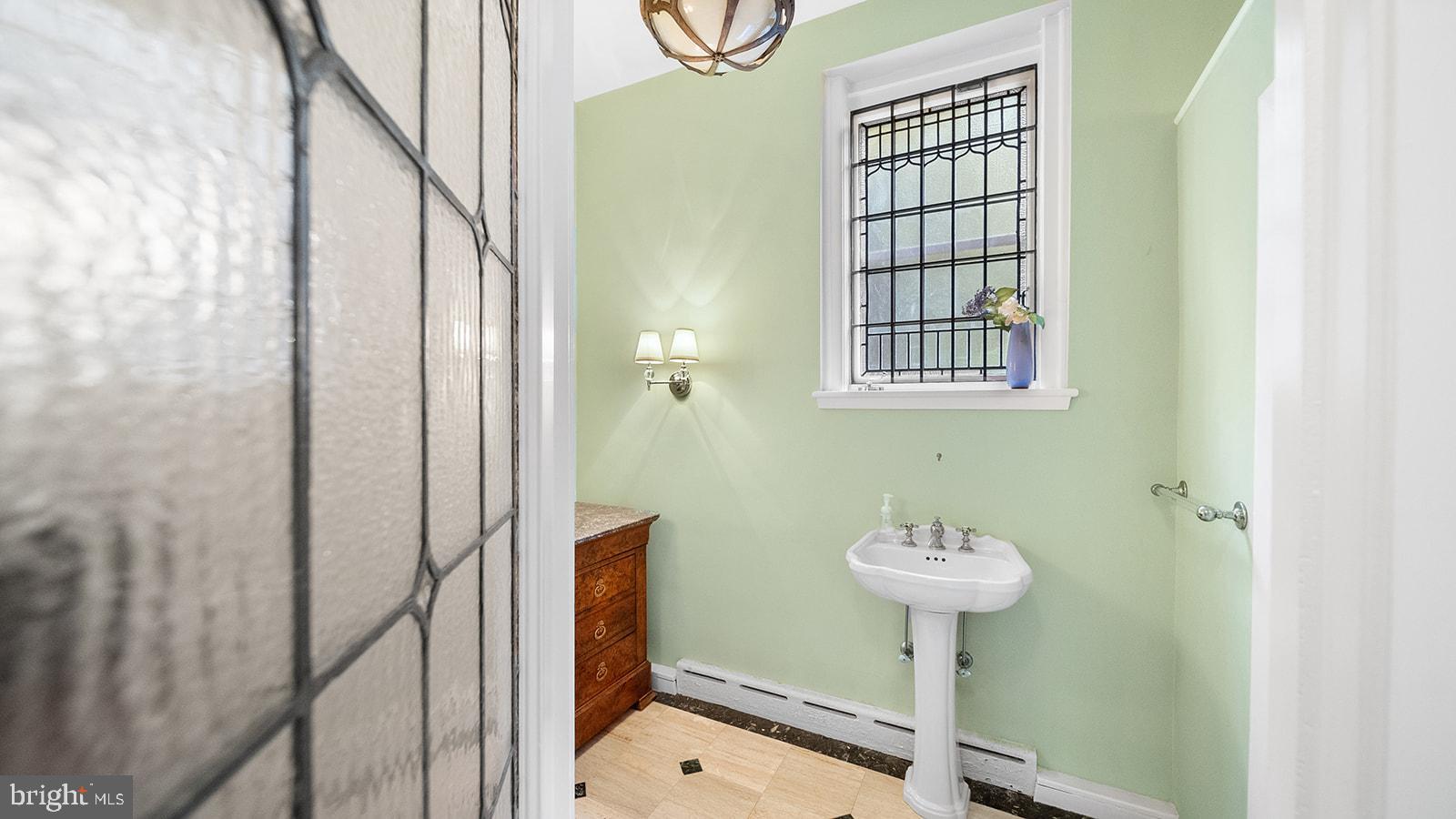 1717 Woodland Road Abington, PA 19001 - Photo 45 of 141 a bathroom with a sink a mirror and a shower