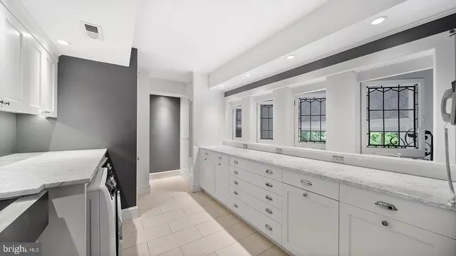 a view of a house with brick walls and flower plants